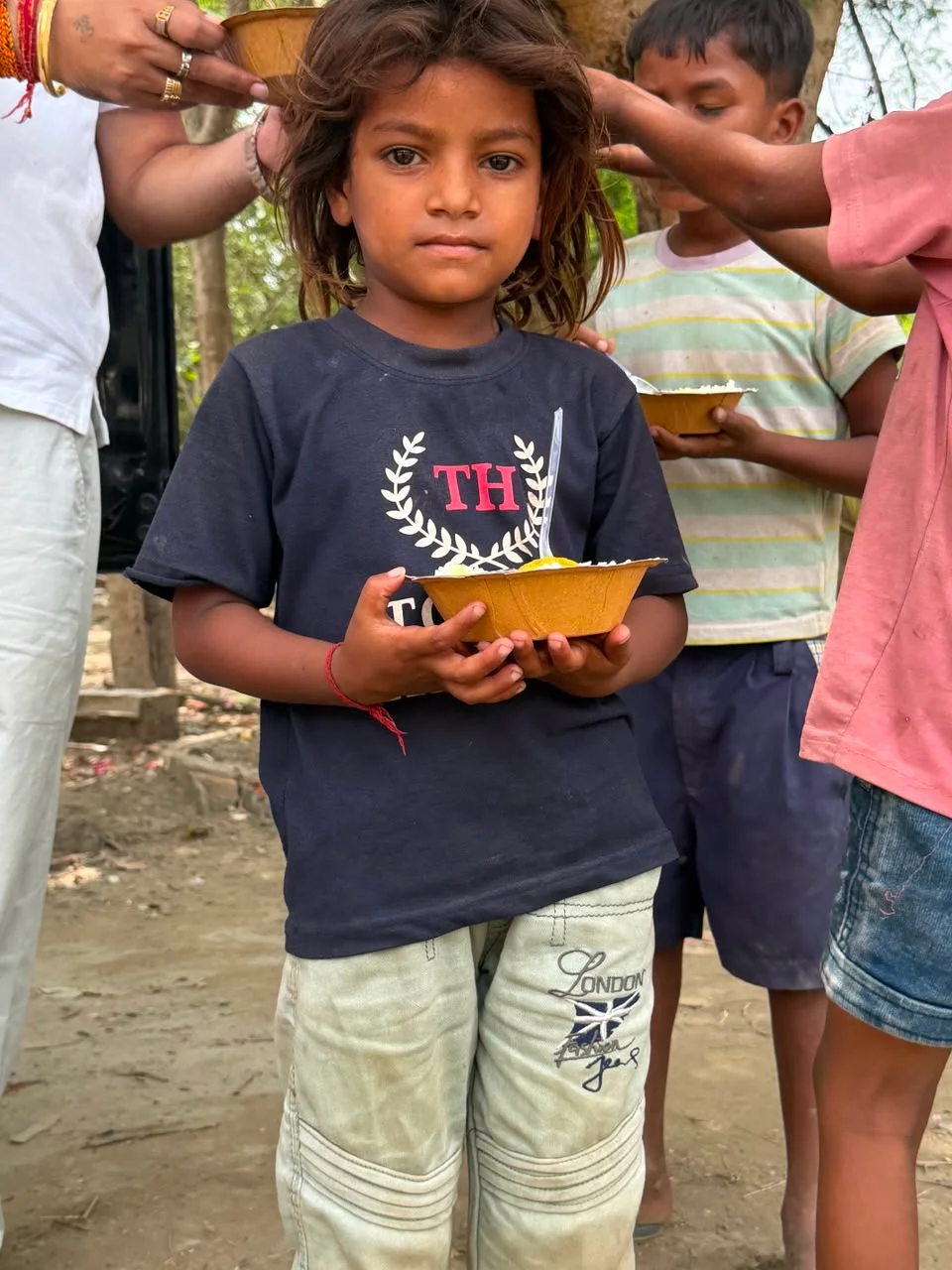 SSF volunteers and children gathered at a foundation celebration event at an ashram — a moment of joy and community support